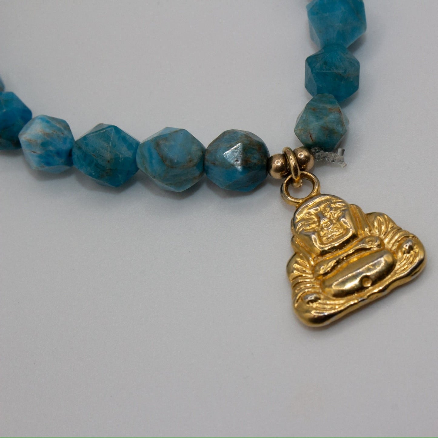 Stretch Turquoise bracelet with gold Buddha charm