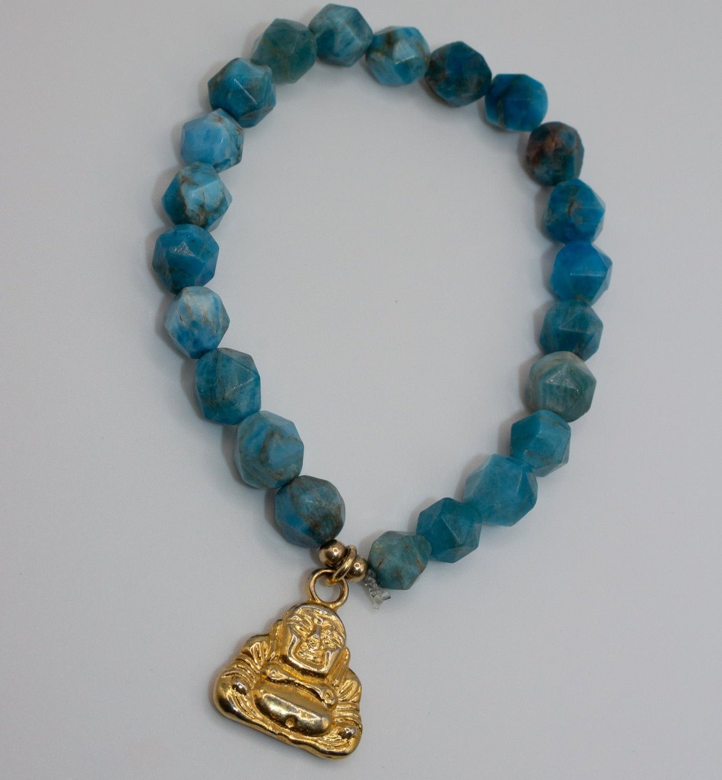 Stretch Turquoise bracelet with gold Buddha charm
